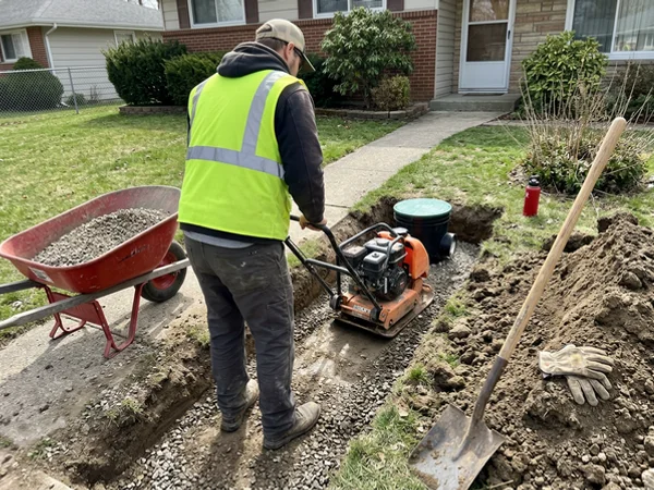 Compacting backfill in lifts around the valve riser